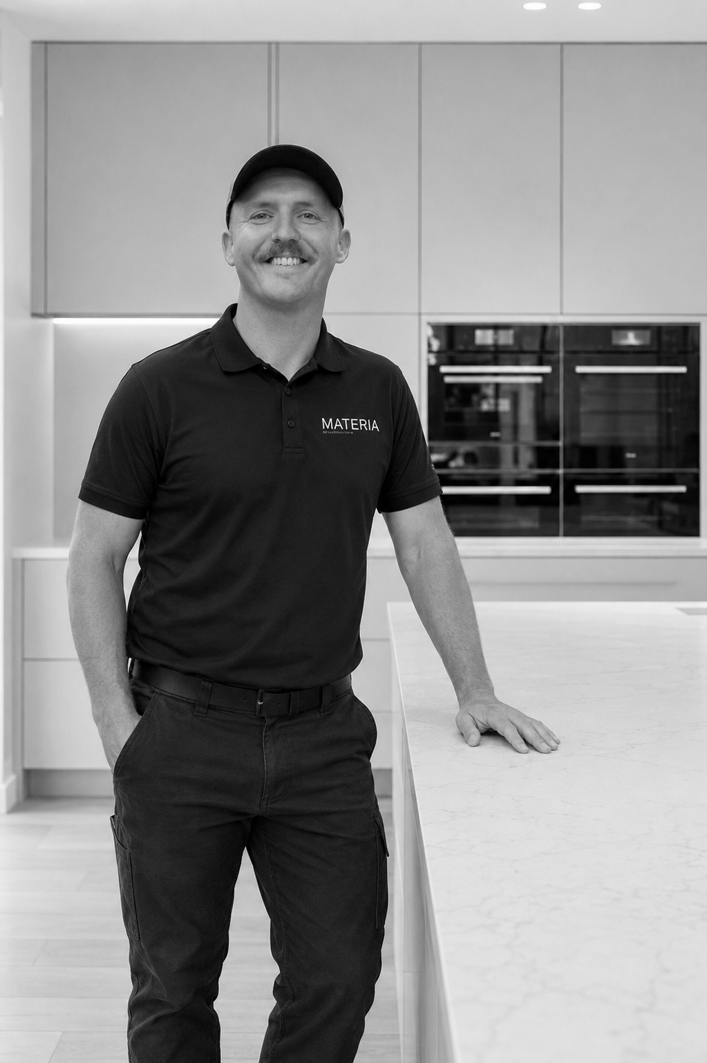 Andy installing cabinetry with a drill on site