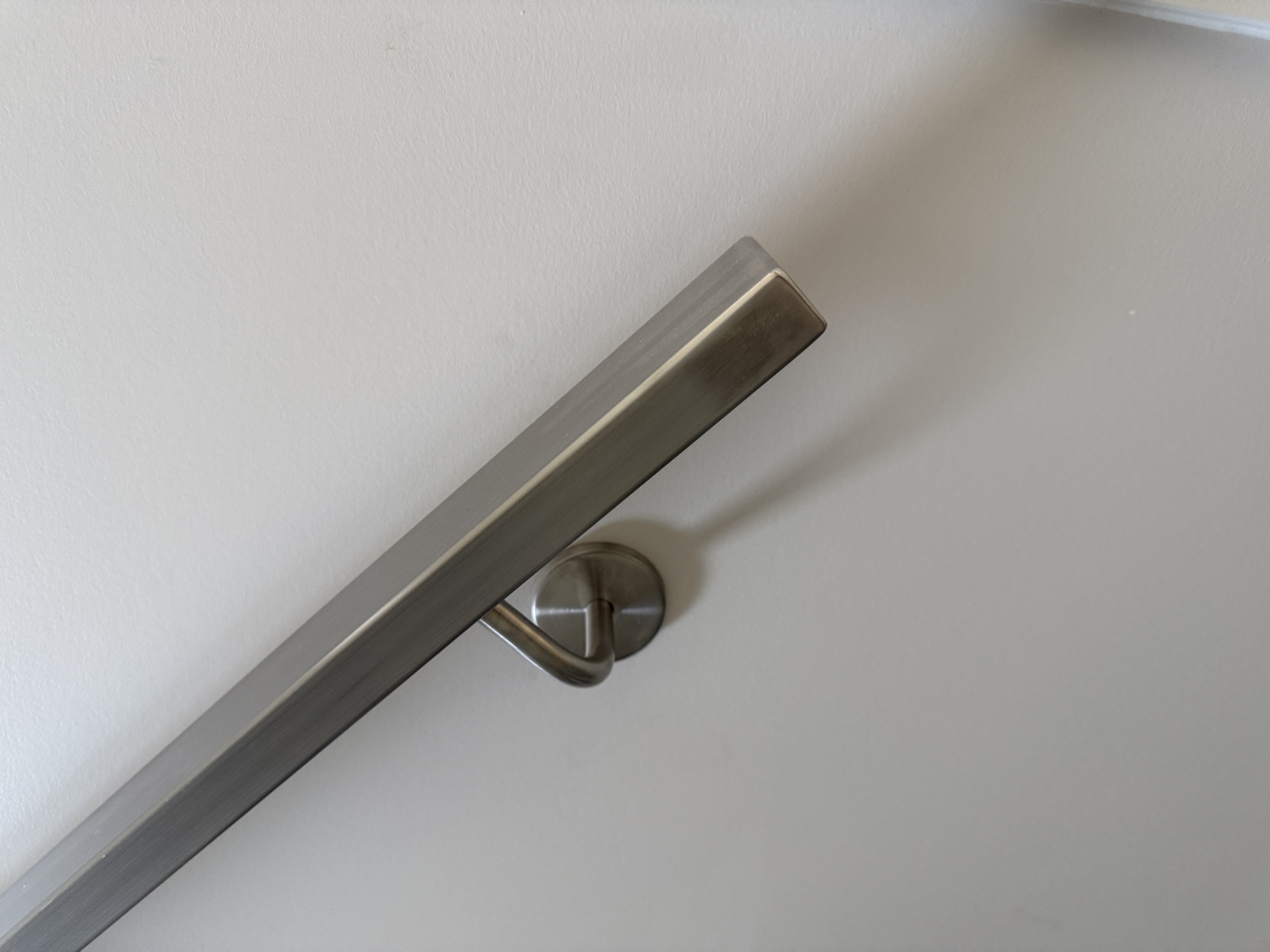 Brushed metal stair handrail detail